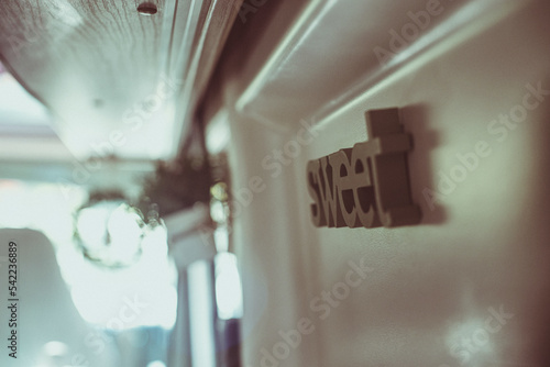 Close-Up of a the word sweet on the interior wall of a camper van photo