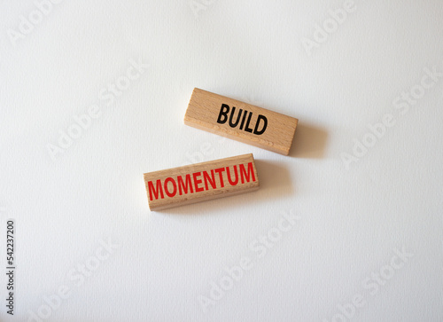 Build momentum symbol. Wooden blocks with words Build momentum. Beautiful white background. Business and Build momentum concept. Copy space.