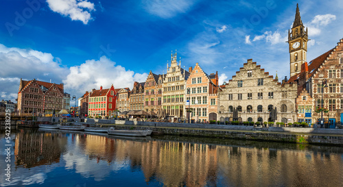 Europe Belgium medieval town travel background - panorama of Ghent canal and Graslei street on sunset. Ghent, Belgium