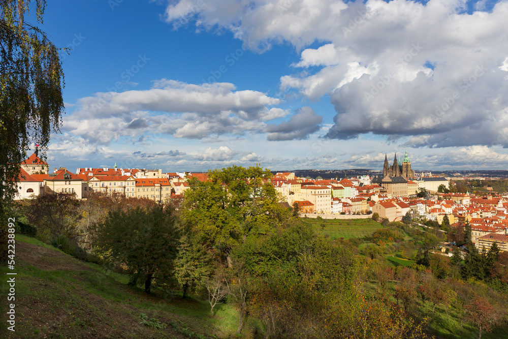 Autumn Prague City with gothic Castle, colorful Nature and Trees with dramatic Sky from the Hill Petrin, Czech Republic