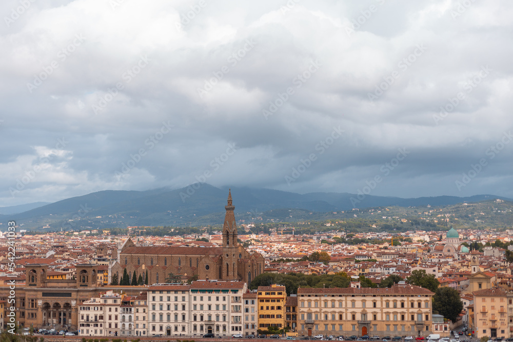Amazing European town with vintage houses and a cathedral near the mountain on a cloudy day. Beautiful Florence
