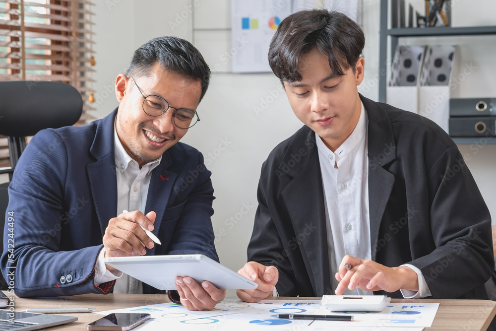 Team of business use calculators and graph analysis computer laptop tablets to plan marketing strategies and make profitable investments for the company. Team of business use calculators and graph analysis computer laptop tablets to plan marketing strategies and make profitable investments for the company.