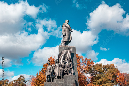 Taras Shevchenko Monument in sunny Kharkiv city center park. Autumn vibes and epic blue sky with white clouds in Shevchenko City Garden, Ukraine photo