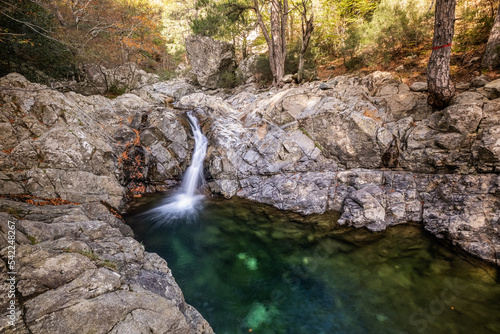 L'Agnone river cascades over rocks into a natural pool in the forest of Vizzavona alongside the GR20 trail in Corsica
