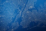 Stylized map of the streets of New York City (New York, USA) made with white lines on abstract blue background lit by two lights. Top view. 3d render, illustration