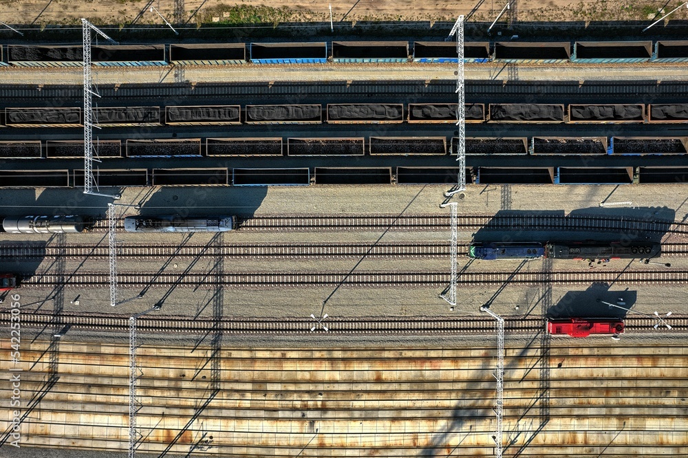 empty wagons are waiting at the train station for coal to be taken to the power plant