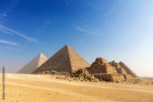 Egypt. Cairo - Giza. General view of pyramids from the Giza Plateau three pyramids known as Queens Pyramids on front side next in order from left: the Pyramid of Menkaure, Khafre and Chufu.
