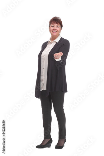 Photo of happy mature woman holding new key and pointing it at camera