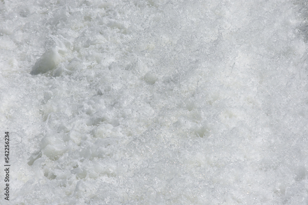 Obraz premium Close up to foam made by water in the rapid section of a river