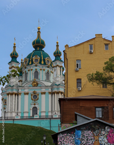 The blue facade of the Church of St. Andrew in Kyiv against the background of the blue sky. Andriyivskyi Uzviz in Kyiv. Architectural monument. Religious buildings. photo