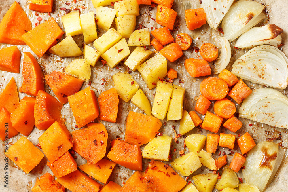 Oven-baked vegetables on a baking sheet. Baked pumpkin, potatoes, carrots and onions. Cooking dinner in the oven. Vegetarian food in the oven. Vegan cuisine. Proper and healthy nutrition Oven-baked vegetables on a baking sheet. Baked pumpkin, potatoes, carrots and onions. Cooking dinner in the oven. Vegetarian food in the oven. Vegan cuisine. Proper and healthy nutrition
