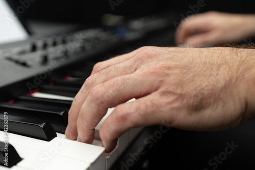 hands playing piano, person playing piano