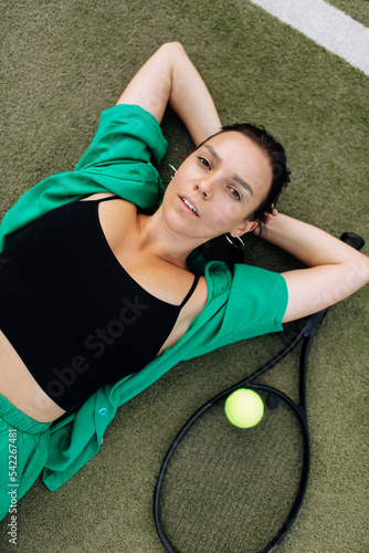 Young woman is playing tennis on sunny day