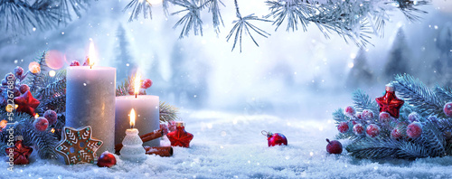 Christmas Decorations With Candles On A Snowy Background. Winter Forest Landscape photo