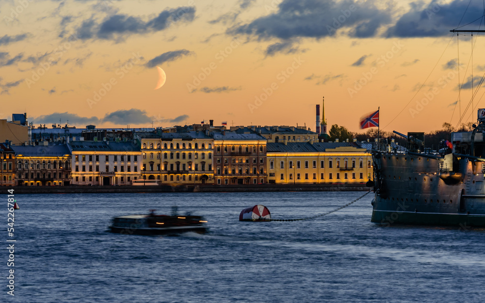Cityscape of Saint Petersburg, Russia. Neva river, Aurora ship and buildings with evening lighting, beautiful night view