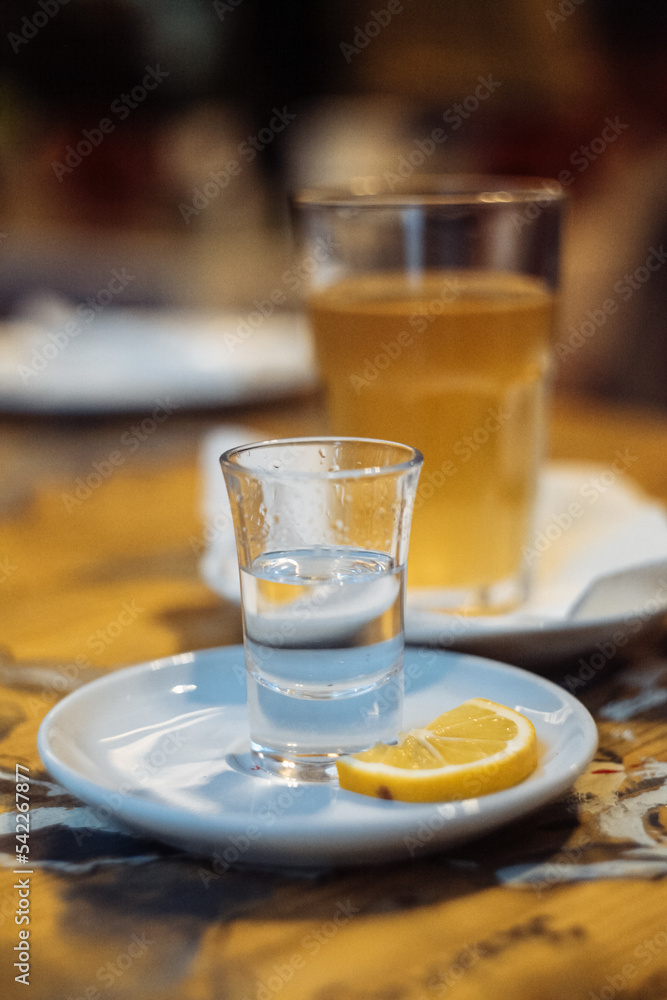 a glass of chacha with a slice of lemon a glass of chacha with a slice of lemon