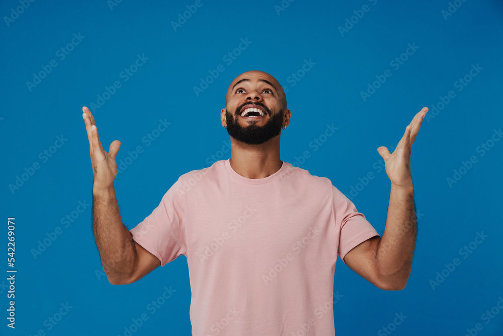 Black bald man with beard smiling and gesturing at camera Black bald man with beard smiling and gesturing at camera