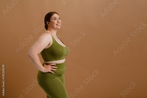 White young woman smiling and posing while standing isolated
