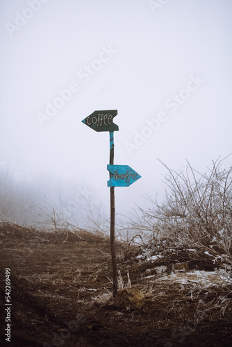 coffee sign in the fog on the road