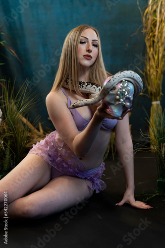 portrait of a woman holding a snake and a skull photo