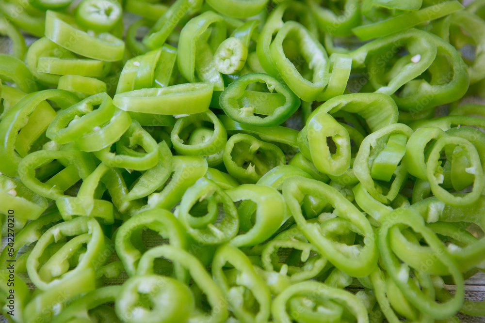 Background of hot green chili pepper cut into pieces. Background of hot green chili pepper cut into pieces.