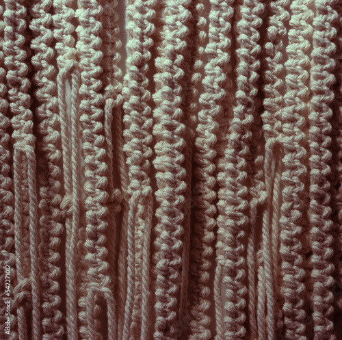 Ropes background. Handmade macrame pattern a fragment of a boho style wall panel. Creative background.