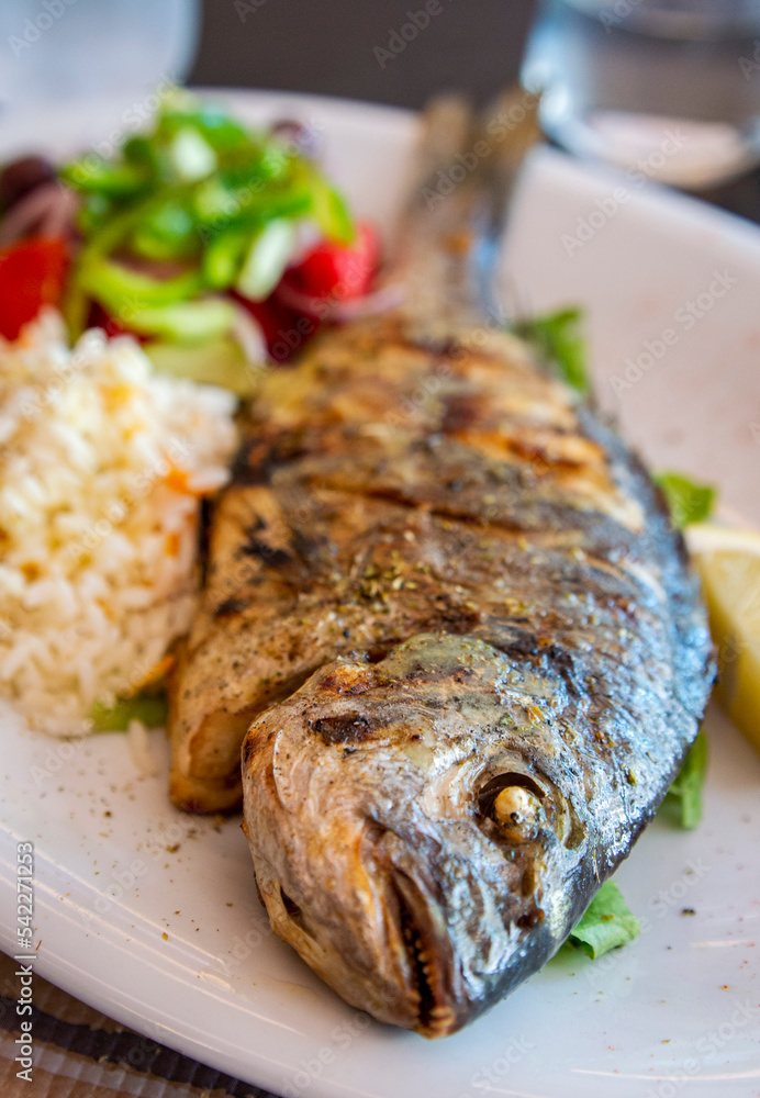 Greek grilled sea bream with rice and salad from a Greece local resturant