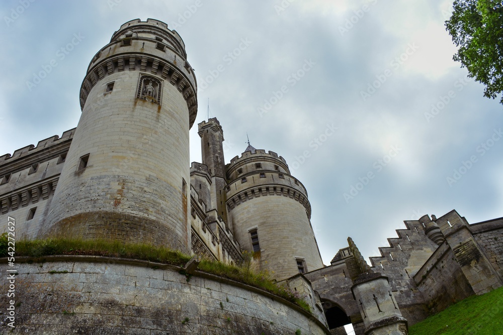 Low angle shot of the towers of chateau castlein france under cloudy sky