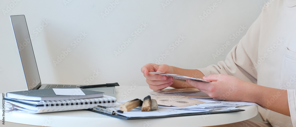 Fototapeta premium Astrology. Astrologer calculates natal chart and makes a forecast of fate.Tarot cards, Fortune telling on tarot cards magic crystal, occultism, Esoteric background. Fortune telling,tarot predictions.