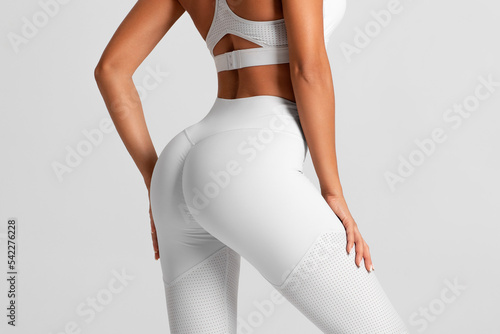 Fitness model in leggings with beautiful buttocks. Sporty booty