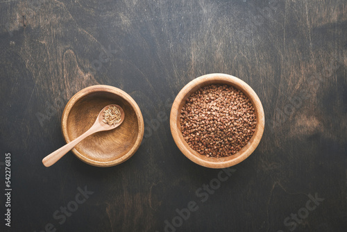World food crisis concept. Empty and full old plate with buckwheat on a dark gloomy background. Concept of global food crisis caused by hunger due to lack of grain. Place for text. Mock up.