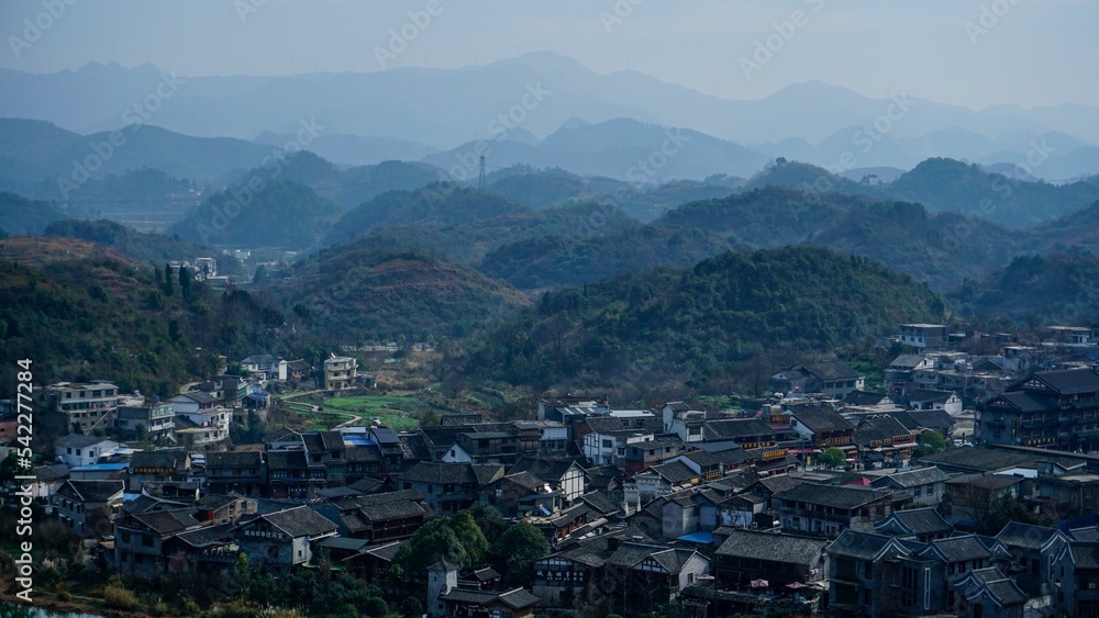 Village in Guiyang China with hill forests and haze in the background