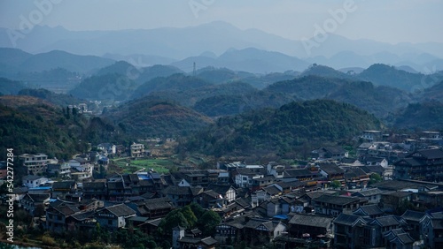 Village in Guiyang China with hill forests and haze in the background photo