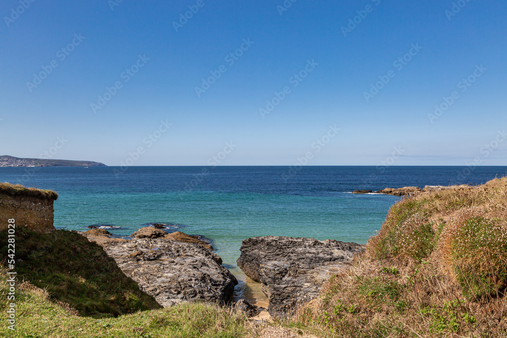A view out over the ocean at Godrevy on the Cornish coast, with a blue sky overhead