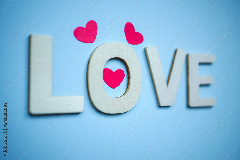 love wooden letters and heart shapes on the blue background for valentine's day love wooden letters and heart shapes on the blue background for valentine's day