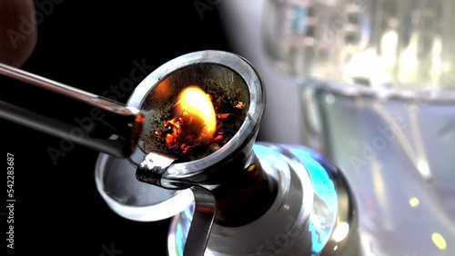 Macro close up smoking medical marijuana bud with bong. Accessories for smoke weed