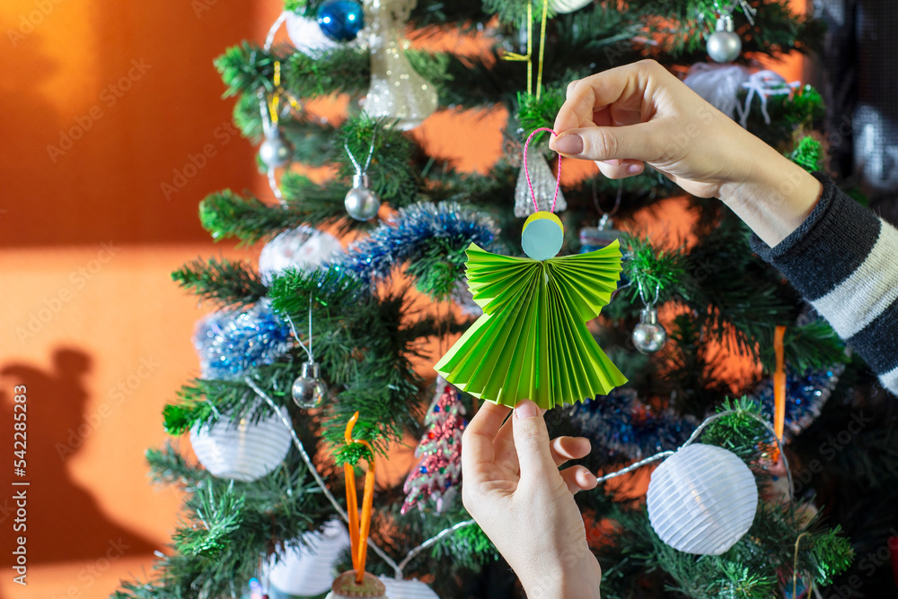 A Young Boy and Girl Decorate a Christmas Tree In Their Home