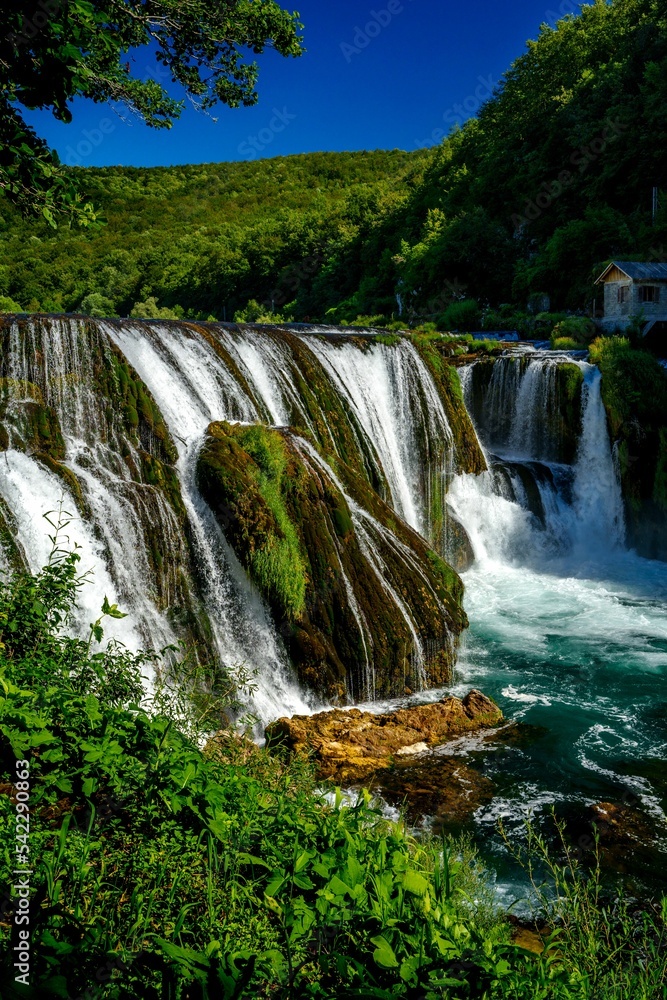 Vertical of the beautiful Strbacki buk waterfall in Bosnia and Herzegovina with foamy water Vertical of the beautiful Strbacki buk waterfall in Bosnia and Herzegovina with foamy water