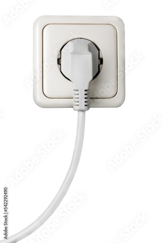 White electrical plug in the electric socket on a wall photo