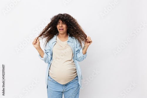 Pregnant woman hair loss during pregnancy, health problems and vitamin deficiencies on a white isolated background in a t-shirt with a blue shirt