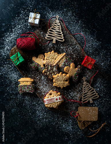 New year and Christmas postcard. Gingerbread cookies on dark background with space for text. Vacation  celebrations and cooking concept.