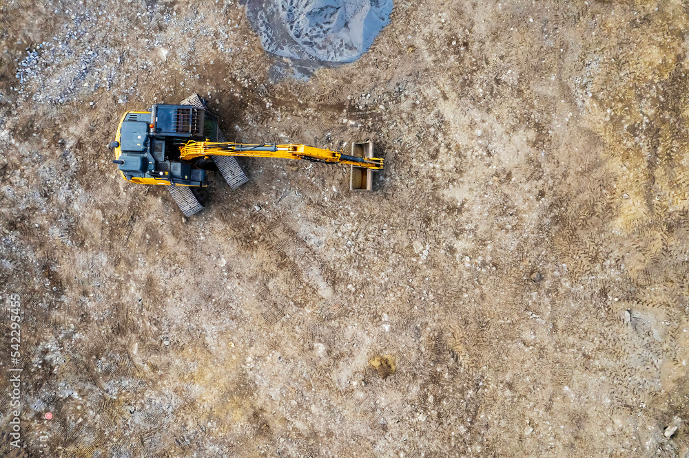 Aerial view on a new construction site . Ground work with excavator. Starting new project. Building industry. Commercial or residential property.