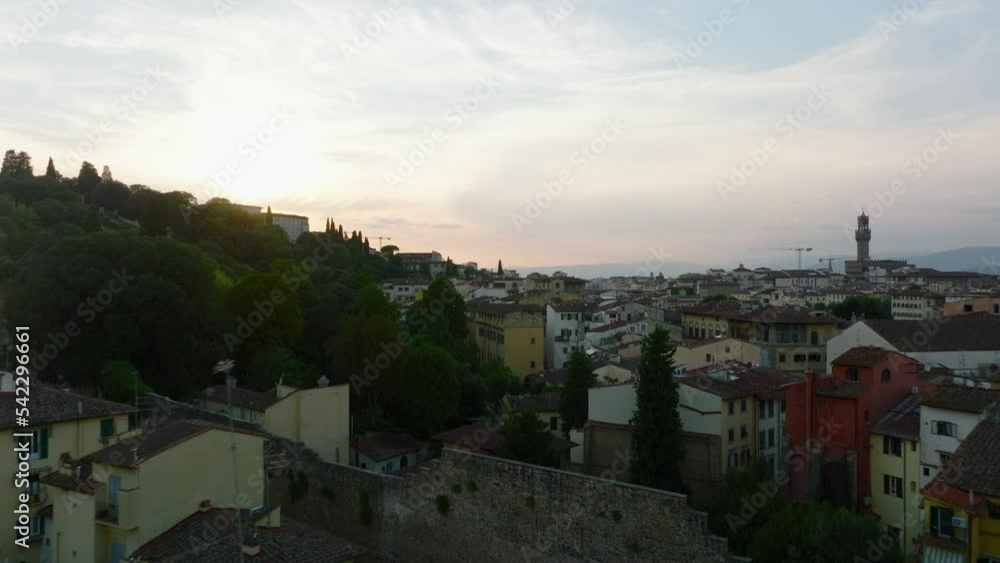 Forwards fly above old stone city walls and surrounding apartment houses. Colour twilight sky. Florence, Italy Forwards fly above old stone city walls and surrounding apartment houses. Colour twilight sky. Florence, Italy