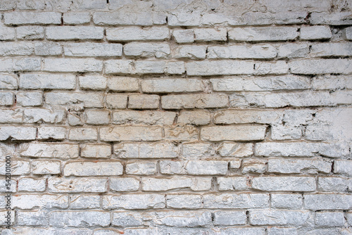 Texture of a weathered white brick wall.