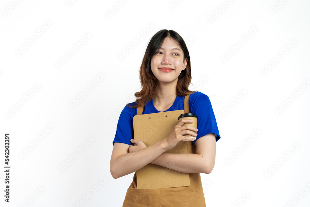 Cheerful young pretty asian woman blue t-shirt and apron coffee owner isolated on white background. Holding paper coffee up and clipboard Cheerful young pretty asian woman blue t-shirt and apron coffee owner isolated on white background. Holding paper coffee up and clipboard