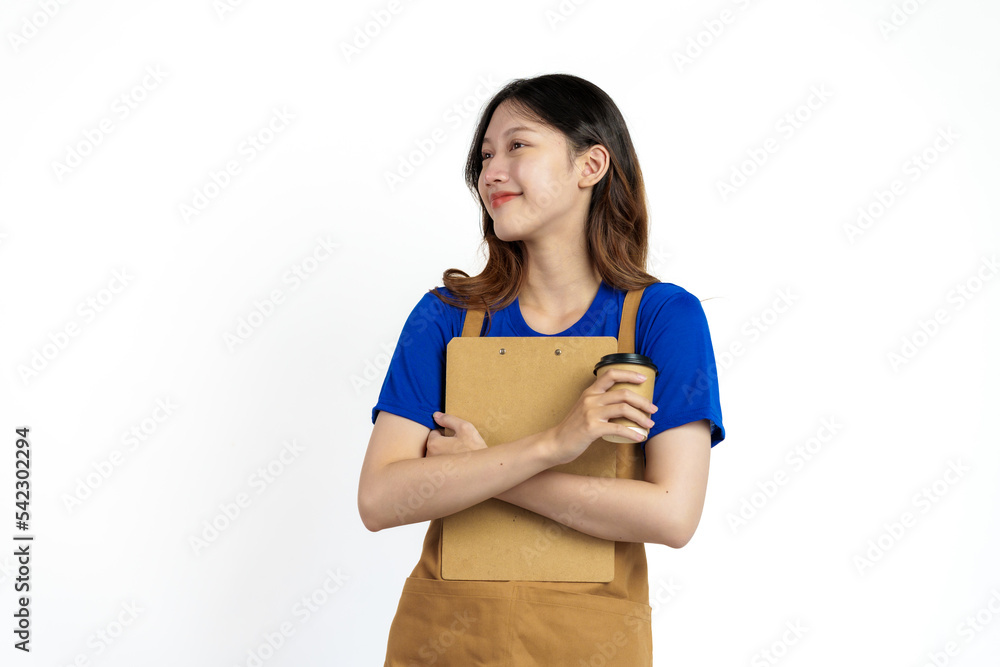 Cheerful young pretty asian woman blue t-shirt and apron coffee owner isolated on white background. Holding paper coffee cup Cheerful young pretty asian woman blue t-shirt and apron coffee owner isolated on white background. Holding paper coffee cup