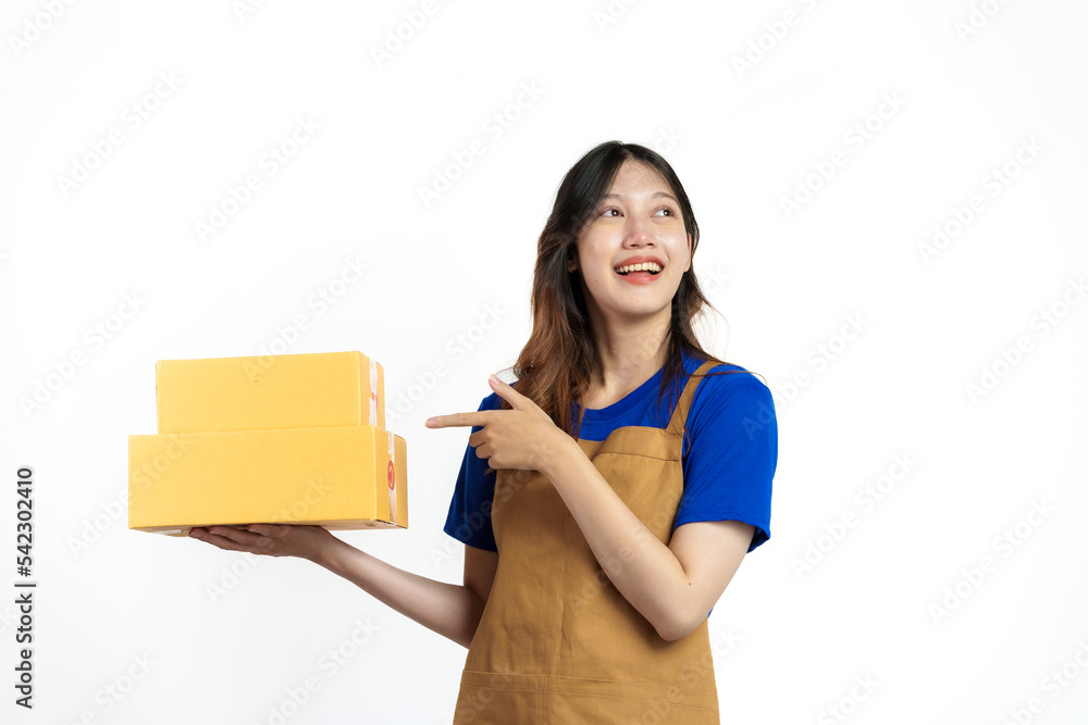 Young pretty asian woman with apron holding packages box of product for delivery sme entrepreneur owner isolated on white background. Young pretty asian woman with apron holding packages box of product for delivery sme entrepreneur owner isolated on white background.