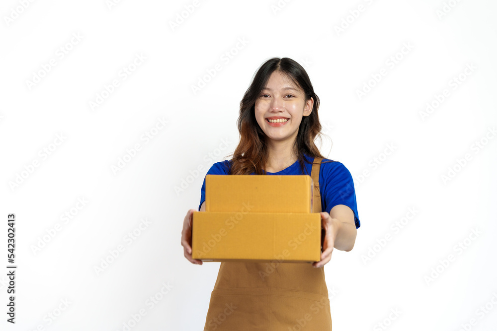 Young pretty asian woman with apron holding packages box of product for delivery sme entrepreneur owner isolated on white background. Young pretty asian woman with apron holding packages box of product for delivery sme entrepreneur owner isolated on white background.