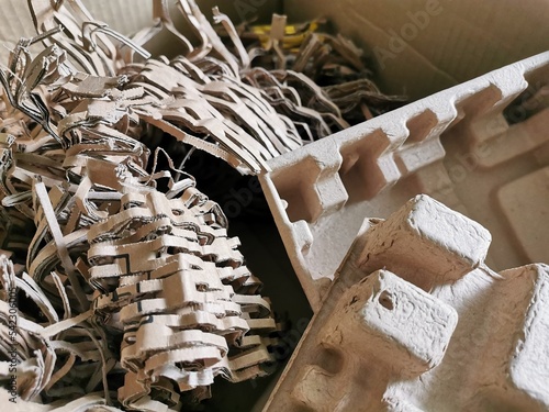 Selelctive focus close up image of brown shredded paper filler for postal package.