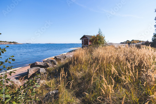 View of Hanko town coast, Hango, Finland, with beach and coastal waterfront, wooden houses and beach changing cabins, Uusimaa, Hanko Peninsula, Raseborg sub-region, summer sunny day photo